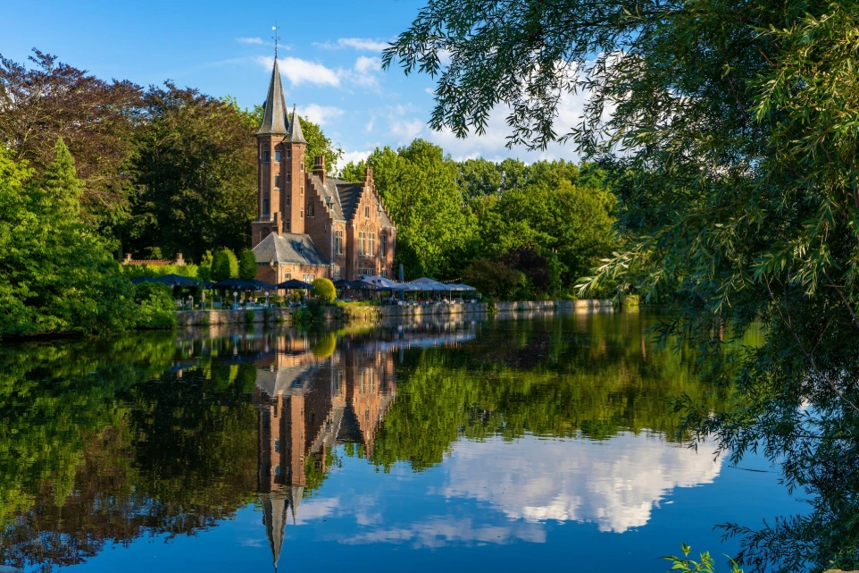 a body of water with trees and a building in the background
